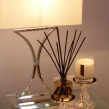 PAIRFUM luxury scented candle and natural reed diffuser on a bedside table in modern house with Elle Decoration