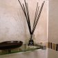 PAIRFUM luxury and natural reed diffuser on a shelf of a modern bathroom