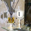 PAIRFUM luxury scented candle and natural reed diffuser on a console table