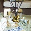 PAIRFUM luxury scented candle and natural reed diffuser on a coffee table