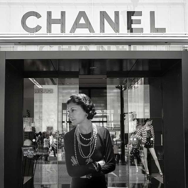 Chanel-standing-in-the-entrance-of-her-Paris-boutique-Chanel-Fragrance House